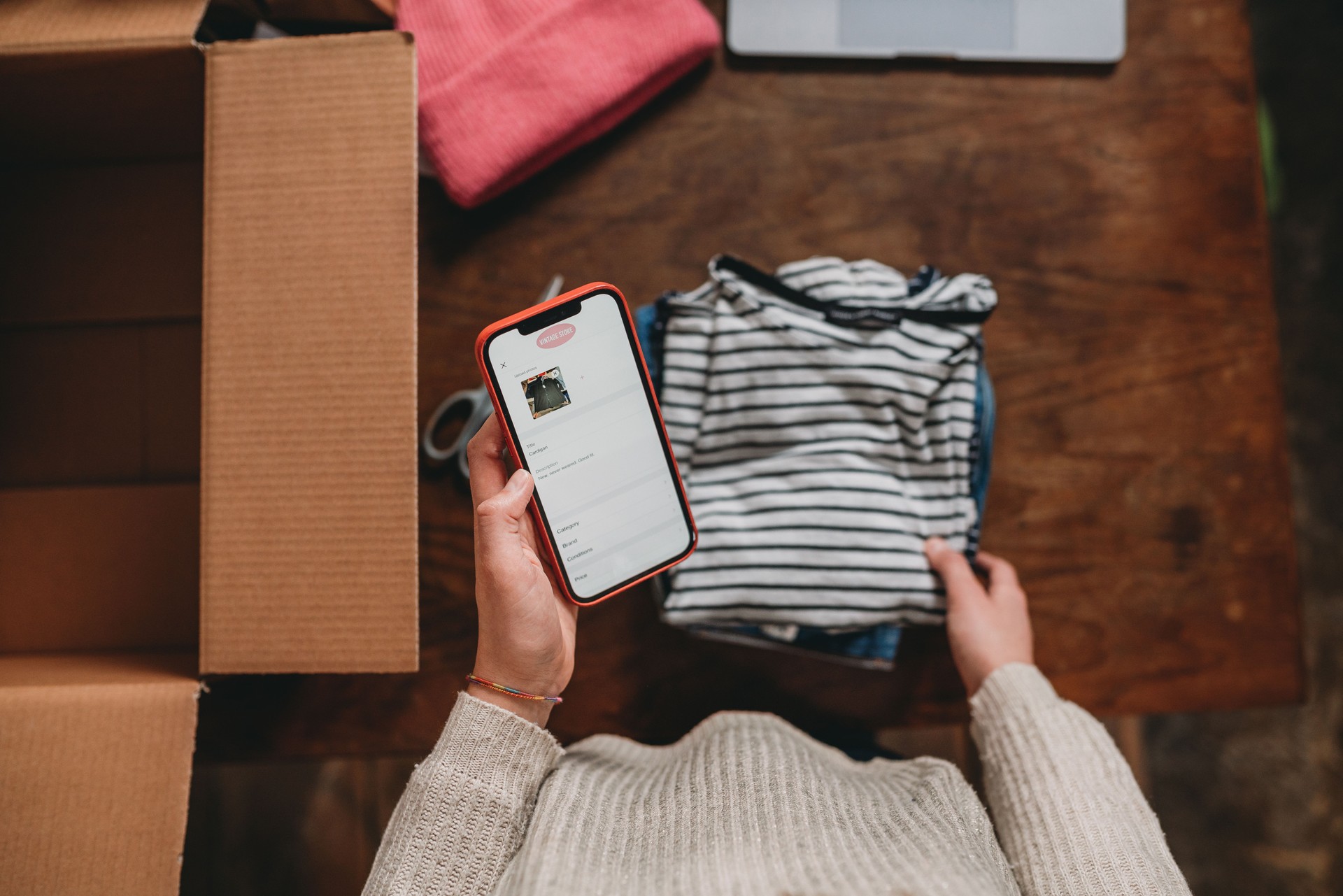 A woman is posting an ad on her online shop